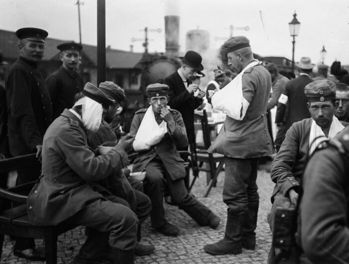 Wounded soldiers with arm slings relaxing outdoors, illustrating so-called facts about history that turned out false.