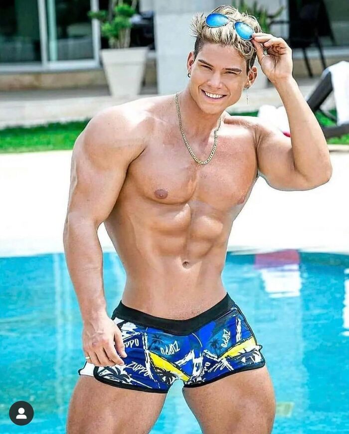 Man by pool with unusually distorted muscles due to obvious Photoshop fails in a bright outdoor setting
