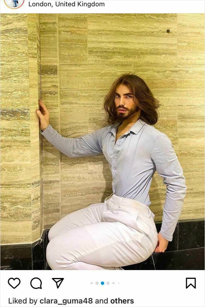 Man with distorted waist and legs posing against beige tiled wall in a Photoshop fails example featuring obvious editing errors.