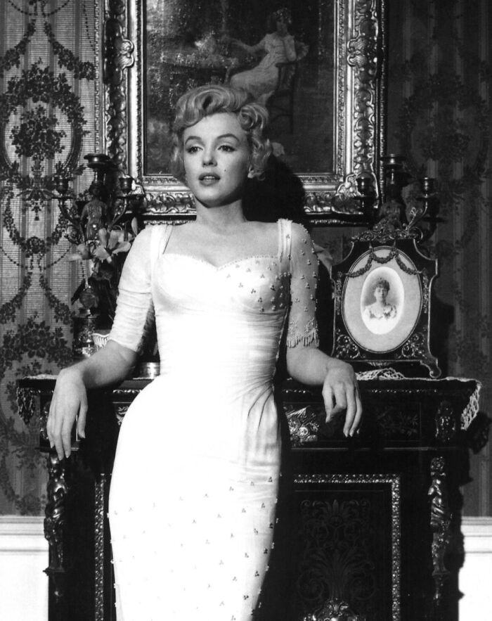 Black and white image of a woman in a vintage dress posing indoors, illustrating so-called facts about history turned false.