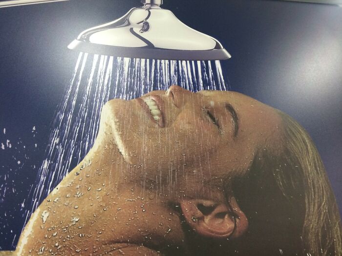 Close-up of a Photoshop fail showing a distorted person under a shower with unnatural water flow and blending errors.