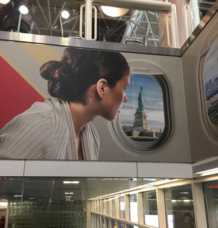 A Photoshop fail showing a woman looking out an airplane window with the Statue of Liberty inserted outside.