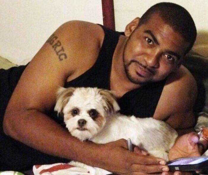 Man lying down holding a small dog, related to celebrities who vanished without a trace and conspiracy theories.