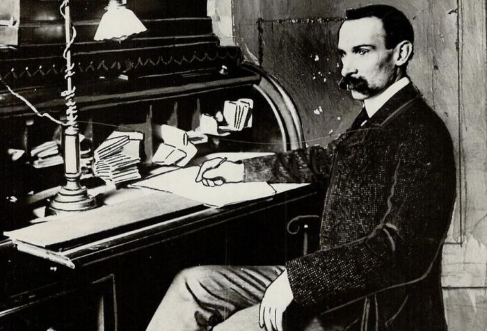 Black and white photo of a man sitting at a vintage desk, representing celebrities who vanished without a trace.