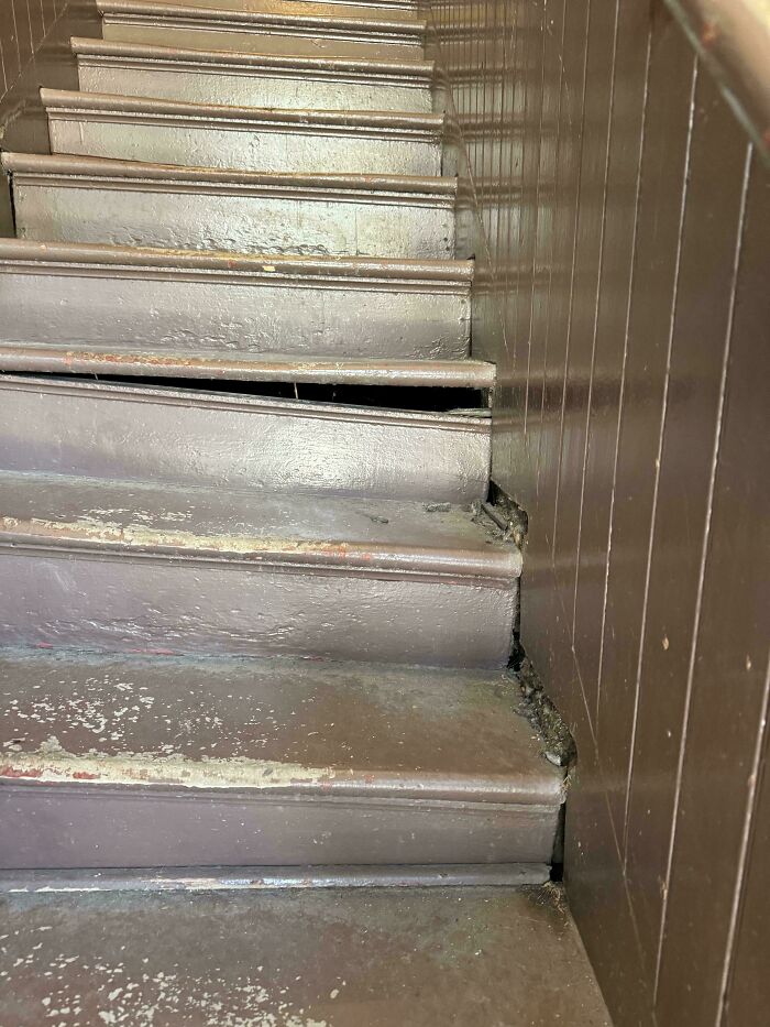Worn and damaged stairs with a broken step, illustrating landlords so horrible renters wanted to run away.