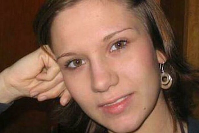 Close-up of a young woman with short brown hair and earrings, part of terrifying photos and stories collection.