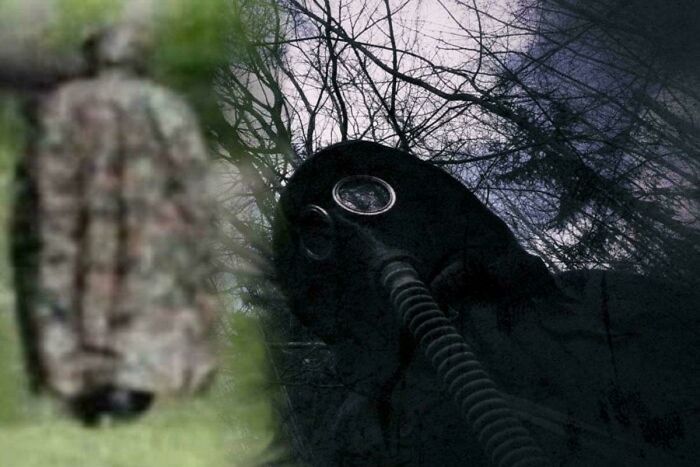 Person wearing a gas mask in a dark forest creating a terrifying and scary atmosphere for haunting photos and stories.