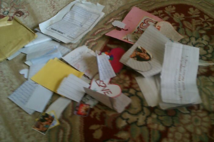 Scattered torn letters and notes on a patterned surface, evoking a sense of mystery and terrifying stories.