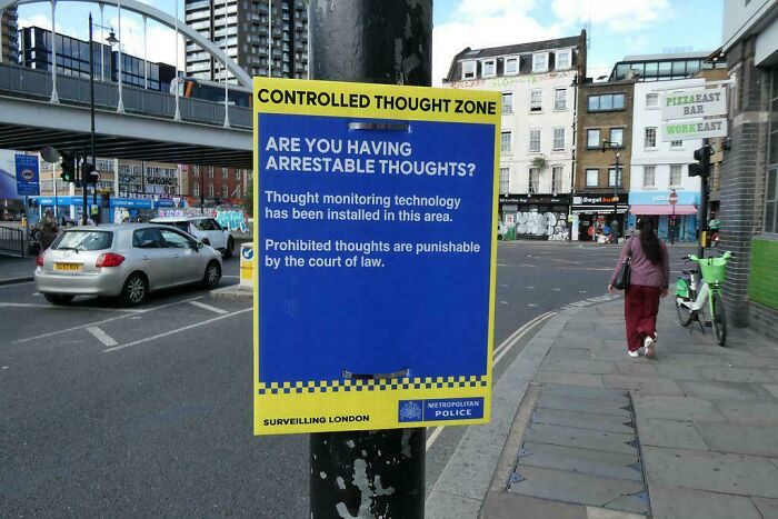 London street sign warning about arrestable thoughts under police surveillance