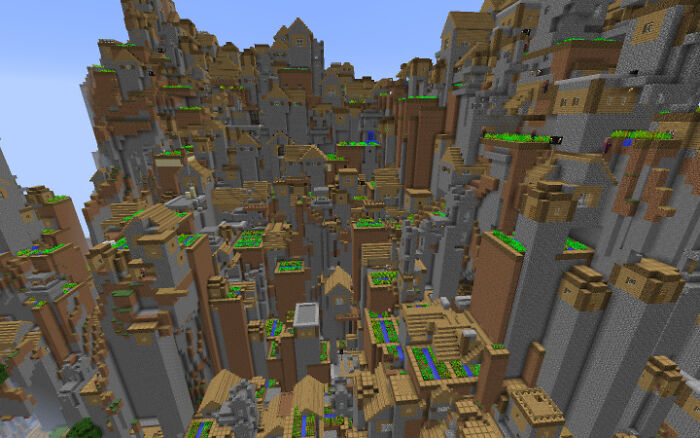 Dense, chaotic Minecraft village built on steep cliffs, illustrating an urban hell environment in a virtual setting.