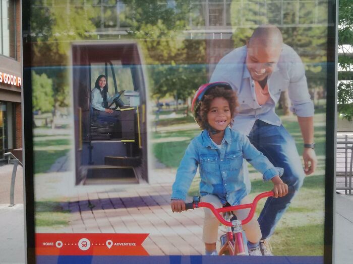 Child riding a bike with an adult helping and a Photoshop fail inserting a woman oddly into the background.