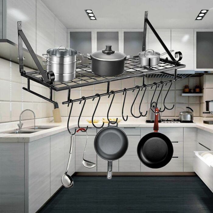 Kitchen rack with pots and pans hanging upside down, illustrating one of the worst Photoshop fails in product design.