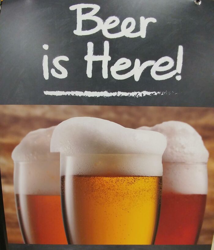 Chalkboard sign saying beer is here above three glasses of beer with excessive foam in a Photoshop fail style.