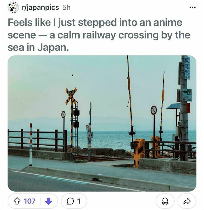 Calm railway crossing by the sea in Japan, capturing a serene urban hell echo chamber scenery.