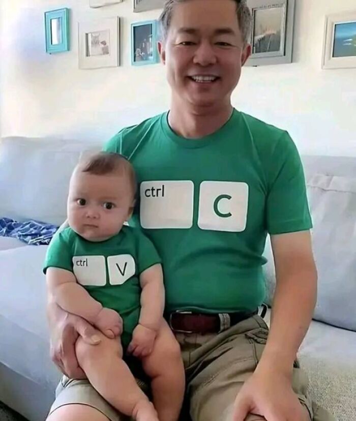 Man and baby wearing matching green programmer shirts with ctrl C and ctrl V keys, creating funny programmer meme.