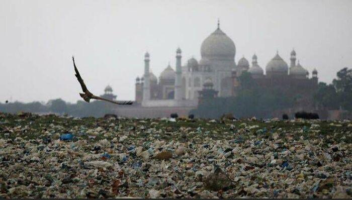 Polluted landscape with plastic waste foreground and historic monument in background, highlighting $58 billion ghost city impact.