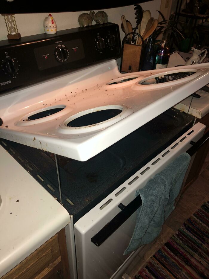 Old stove with a dirty, removable cooktop showing everyday things that humble fully grown adults in kitchens.