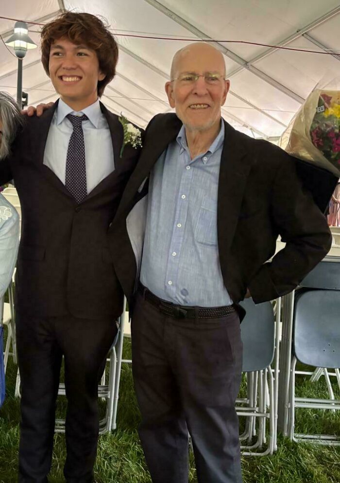 Young man and elderly man in suits posing under a tent showing random comparisons that mess with perception of time.