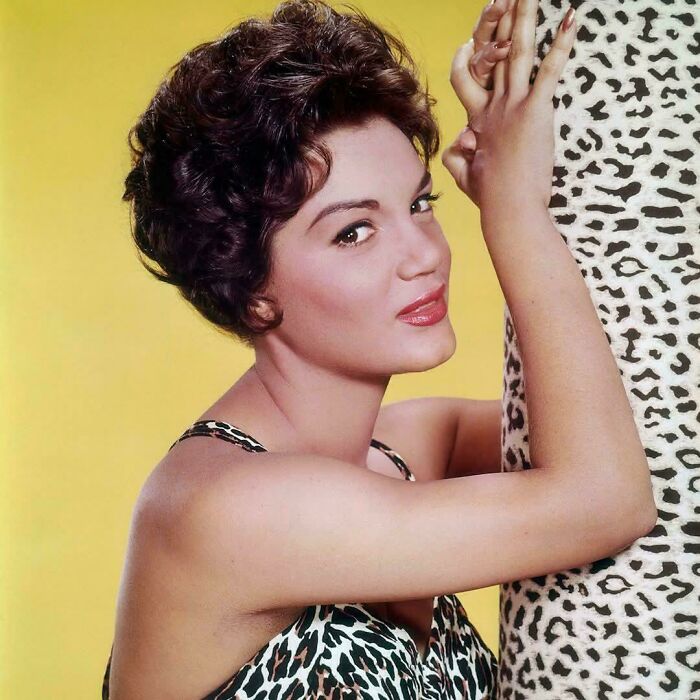Vintage portrait of a woman in a leopard print dress and matching backdrop, illustrating random comparisons that alter perception of time.
