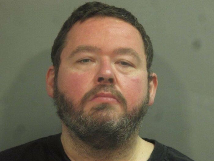 Portrait of a bearded man with short dark hair, shown in a neutral expression, illustrating perception of time concept.