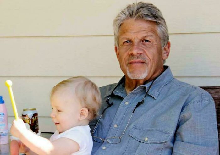 Older man with a toddler on his lap illustrating a random comparison affecting perception of time from an online group discussion.