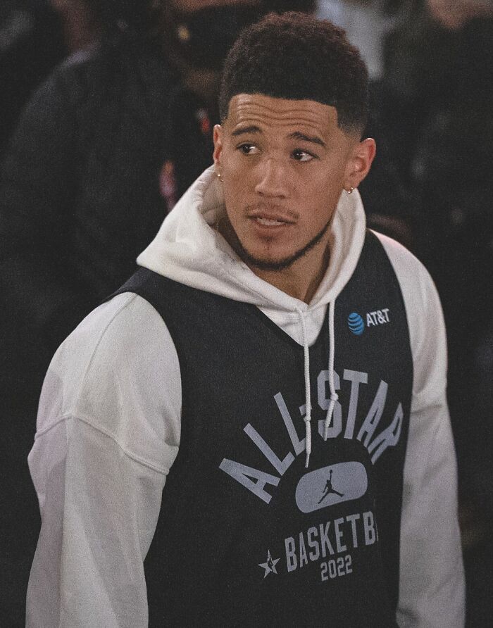 Young athlete wearing a basketball All-Star 2022 vest in a crowd, representing highest paid athletes 2025.