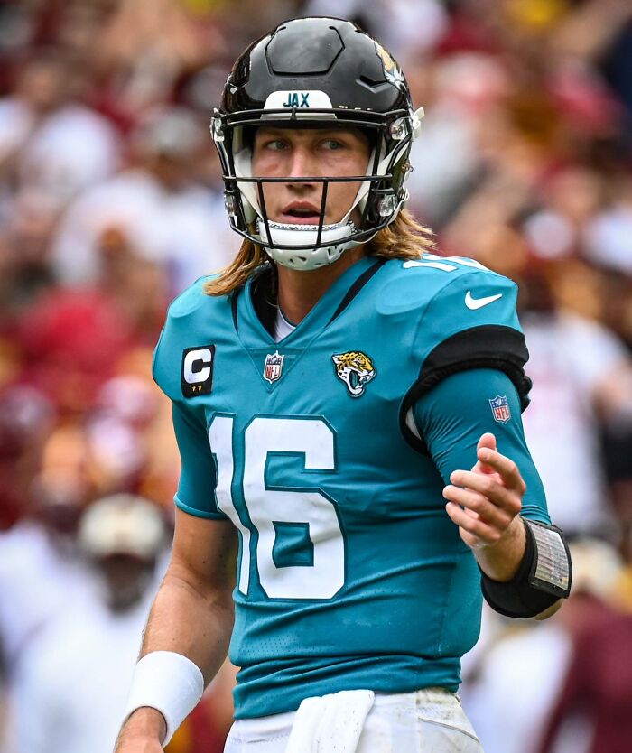 American football player in teal uniform and helmet during a game showcasing highest paid athletes 2025.