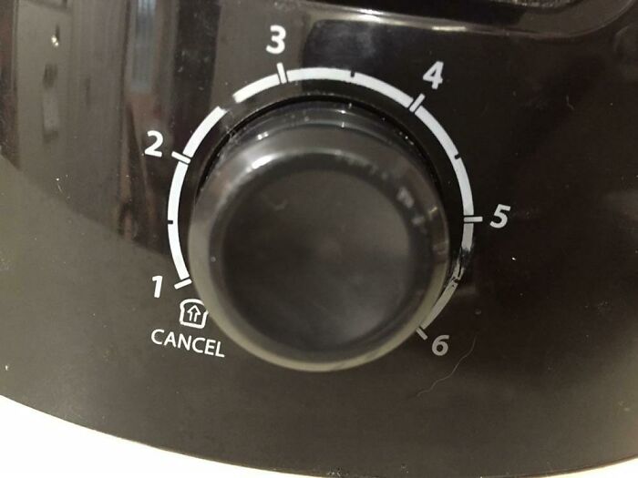 Close-up of a black appliance dial with numbered settings, one of the everyday things that humble fully grown adults.