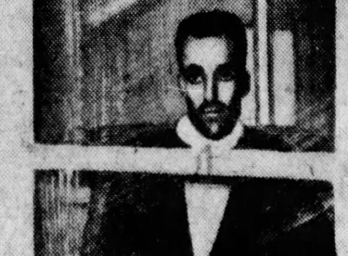 Black and white vintage photo of a man behind bars, illustrating a history anecdote from the past.