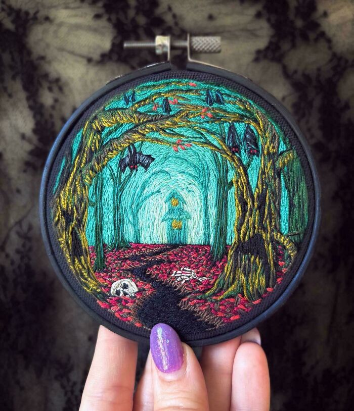 Dark, intricate embroidery creations of a forest with hanging bats and a path leading to a glowing house, a unique hobby.