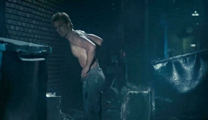 Scene from a bad movie showing a shirtless man in a dark alley, highlighting confusing bad movie details.