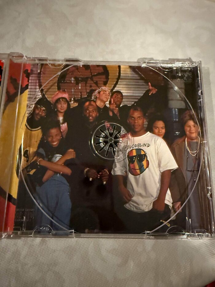 Group of diverse young people posing for a 90s photo inside a CD case, evoking nostalgic 90s memories and style.