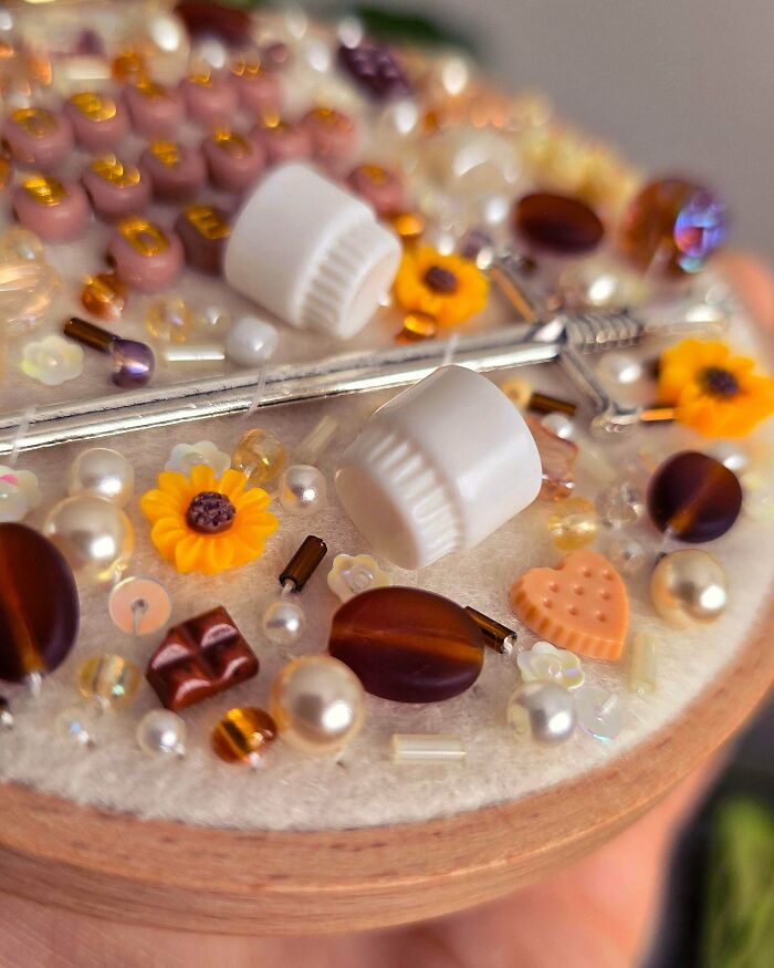 Detailed embroidery creations featuring various beads, pearls, and miniature sunflowers, perfect for a new hobby.