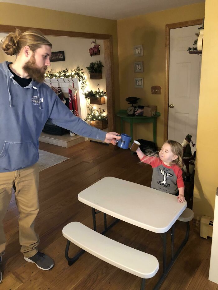 Man and child having tea in a perfectly timed photo capturing steam mid-air, showcasing moments better than Photoshop.