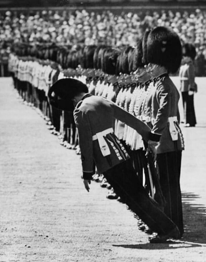 Guard leaning forward at an impossible angle during a perfectly timed photo of a military parade without any Photoshop.