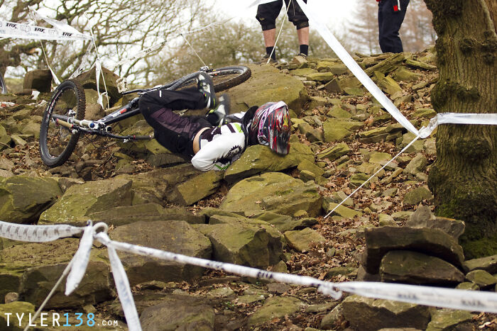 Mountain biker mid-crash on rocky trail, captured in a perfectly timed photo better than any Photoshop.