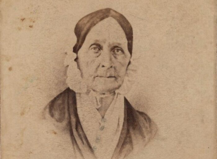 Sepia-toned portrait of an American folk hero woman from the 19th century, representing American folk heroes history.