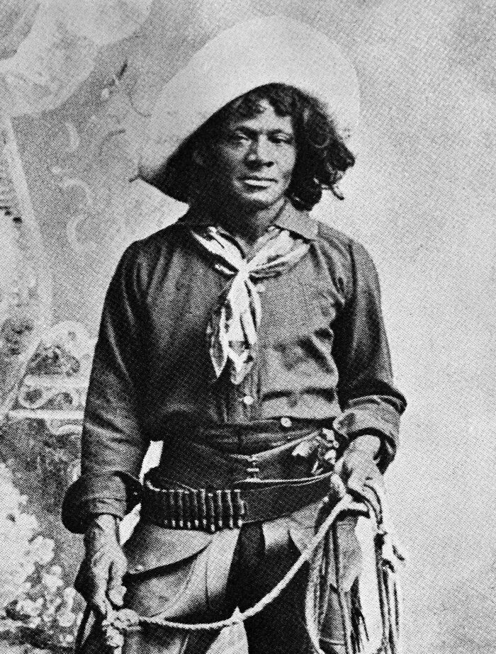 Black and white photo of an American folk hero in traditional attire holding a rope, symbolizing folk hero stories.