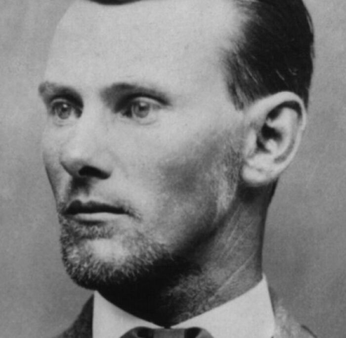 Black and white portrait of an American folk hero with a serious expression in a vintage style photograph.