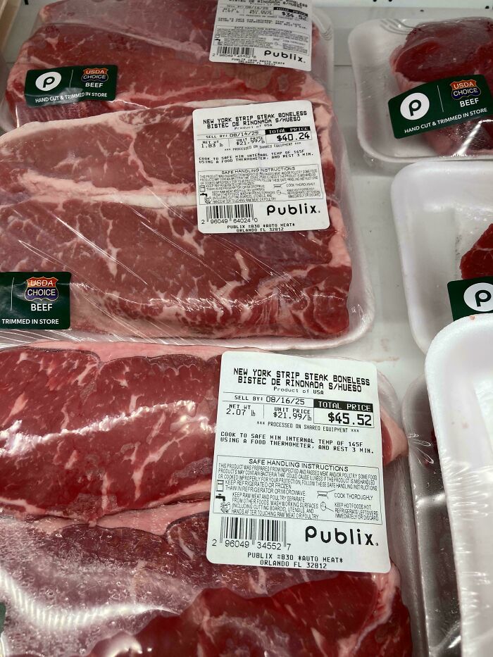 Packages of USDA choice beef with high prices displayed at a Publix store, reflecting dystopian real-life scenes in the US.