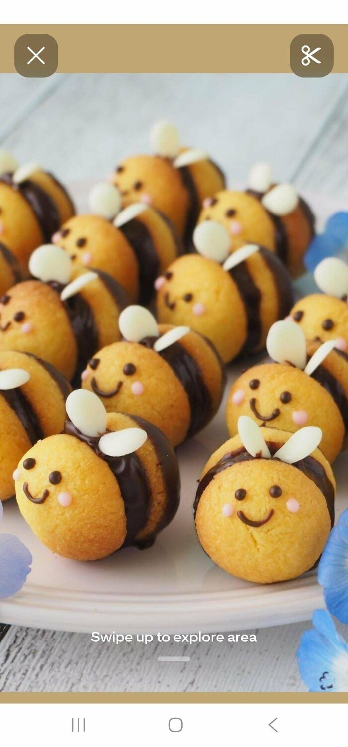 Cute baked goods shaped like bees with smiling faces and chocolate filling, showcasing gorgeous baked goods creativity.