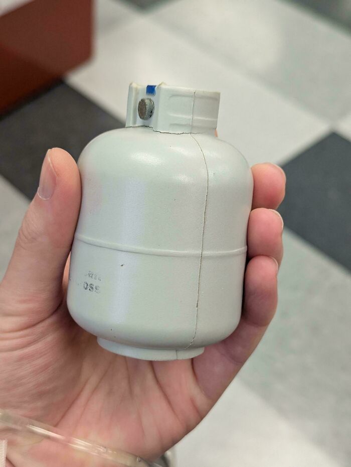 Hand holding a small c*****d object showing something moderately interesting to share with the world.