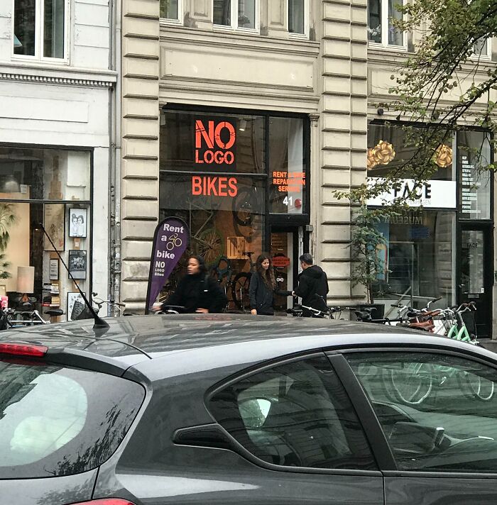 Bicycle rental shop in Denmark with people outside, showcasing Danish urban culture and lifestyle.