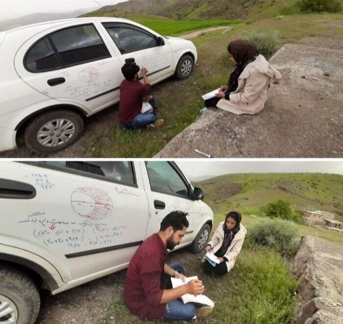 Two students studying math outside with equations written on a car, capturing wholesome posts and uplifting moments.