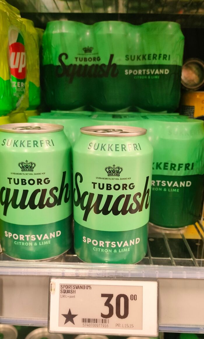 Cans of Tuborg Squash sportsvand citron & lime displayed in a fridge in Denmark, highlighting Danish beverage culture.