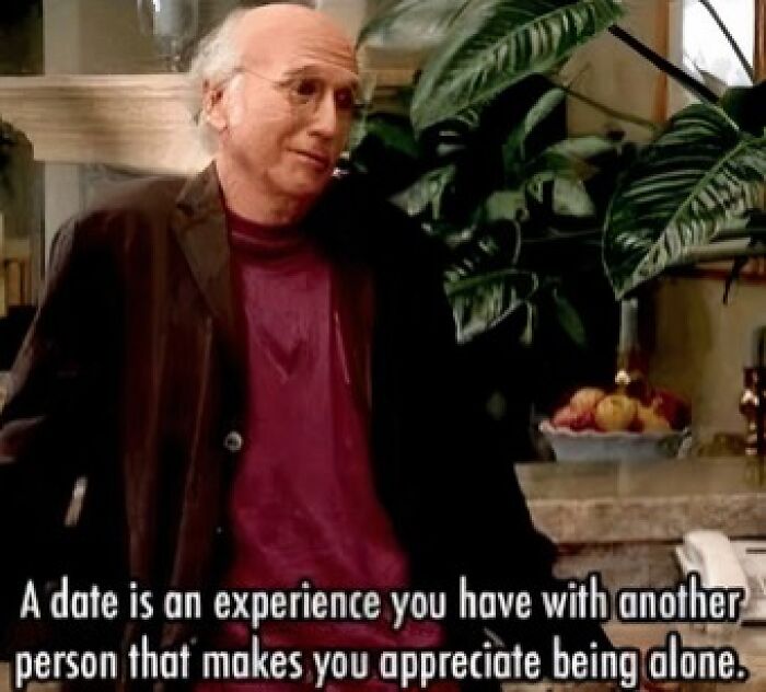 Man in casual clothes sharing a humorous quote about dating and appreciating being alone, surrounded by plants.