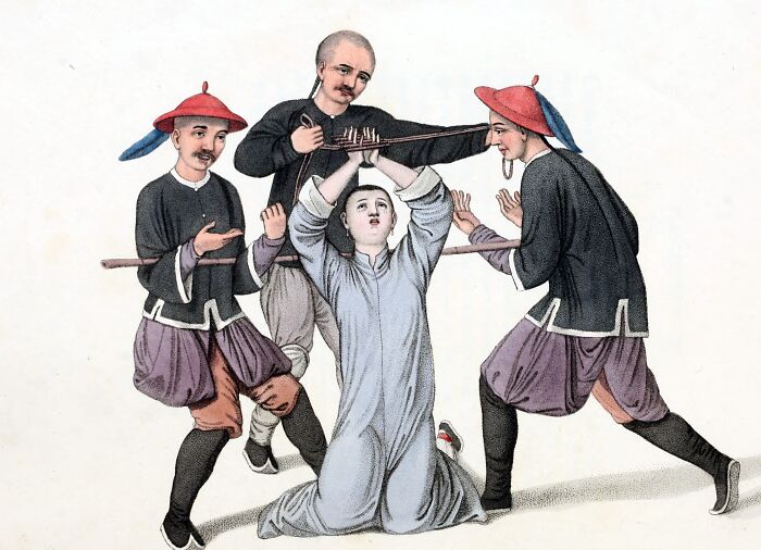 Medieval history t*****e method showing three men restraining a kneeling figure with a painful device around the neck and arms.
