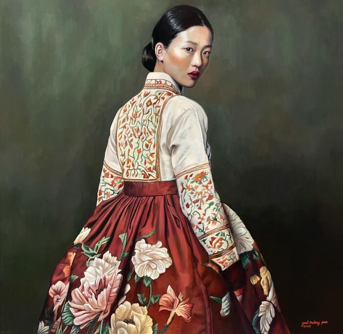 Painting of a woman in a colorful floral traditional dress celebrating women’s strength and beauty across cultures.
