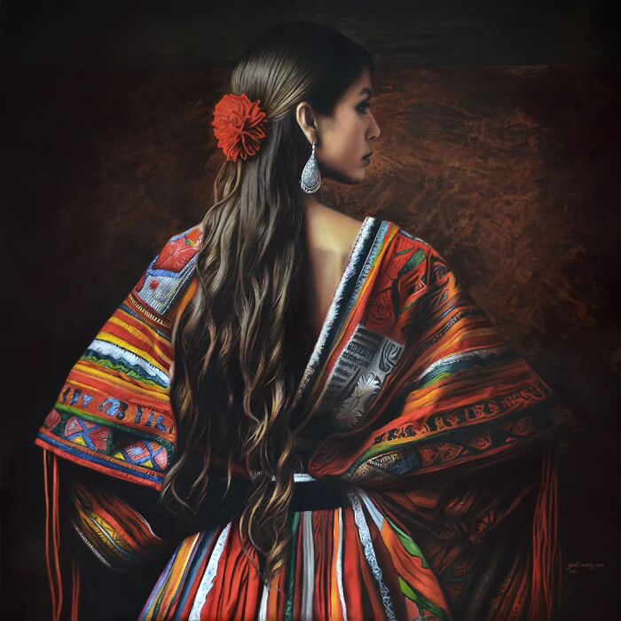 Woman with long hair and red flower wearing colorful traditional clothing, celebrating women’s strength and beauty.