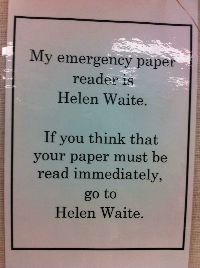Funny teacher sign with a humorous message about an emergency paper reader named Helen Waite in a classroom setting.